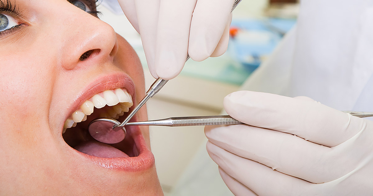 woman being examined by dentist